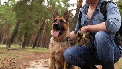 Trekking through the woods, Man and dog relaxing, German Shepherd with owner in forest, Nature escape for two, Best friends outdoors, Bonding in fresh air, Dog owner adventure, Leisure time in the