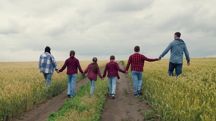 agriculture, children running for boys and girls, Hand hand kids and adults in country field, Togetherness in open wheat landscape, Outdoor playtime with family and friends, Youthful energy in family