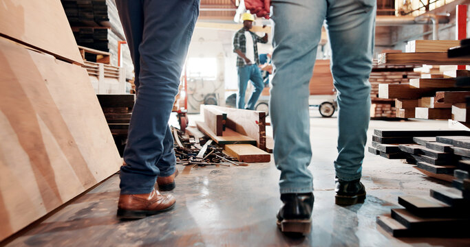 Carpentry, walking and legs of people in factory for woodworking, timber production and teamwork. Carpenter, collaboration and back of workers in workshop for lumber, wood and construction business