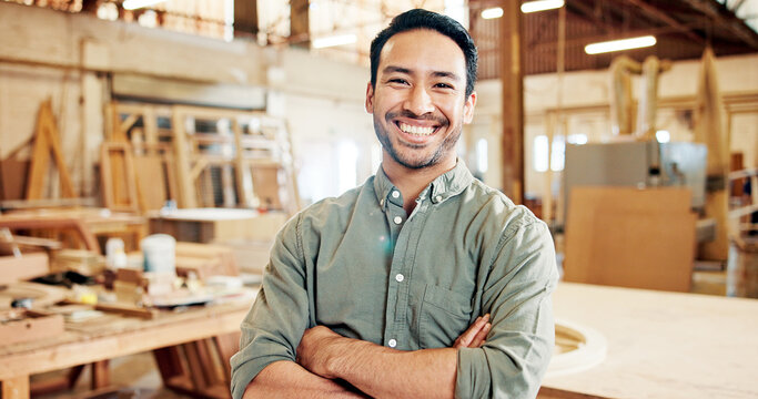 Man, carpenter and arms crossed in portrait at factory with pride, smile and furniture manufacturing. Person, small business owner and happy with woodwork, craft or excited at workshop in Indonesia