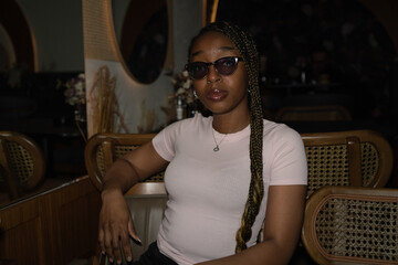 Portrait of a young black woman in a restaurant