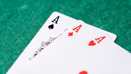 A set of playing cards with aces on a green background, representing the concept of cards and gambling games. High quality photo