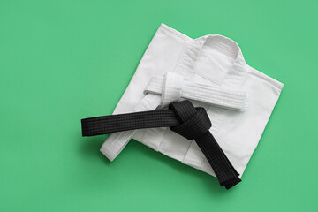 Karate uniform with belts on green background