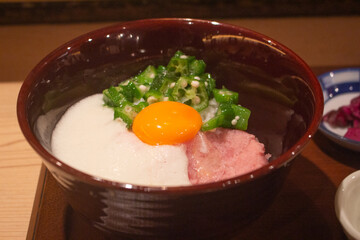 Top down view of a bowl of negitoro or minced tuna, tororo and okra rice with raw egg topping. Japanese food. Tokyo, Japan