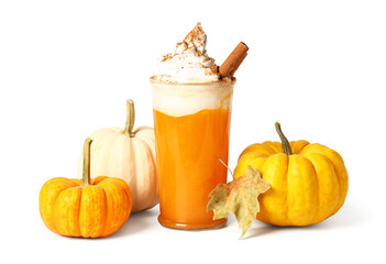 Glass of orange pumpkin spice latte and pumpkins isolated on white background, closeup