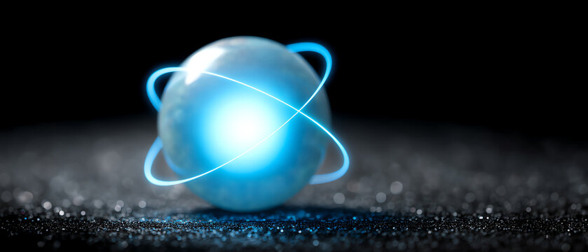 A glowing blue sphere with luminous orbiting rings sits on a reflective surface against a dark background, evoking a futuristic or atomic energy concept