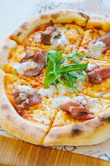 Delicious pizza topped with beef and fresh greens