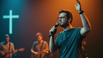 Man singing and worshipping with microphone during Sunday service, with an illuminated cross and band members in the background