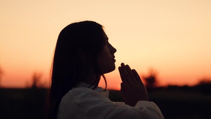 Silhouette woman girl praying, man believing God, woman girl asking forgiveness sunset, looking up sky, praying, giving thanks, asking help, meditative eyes closed, girl praying silhouette, seeking