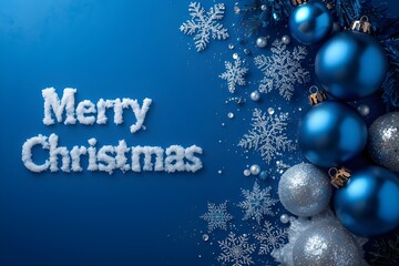 ''Merry Christmas'' greeting written in snow on a blue background with Christmas decorations.