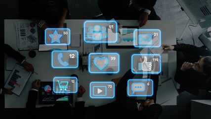 A dynamic business meeting scene showcasing diverse professionals engaged in discussion, surrounded by digital communication icons representing various metrics and analytics. Raster - Powered by Adobe