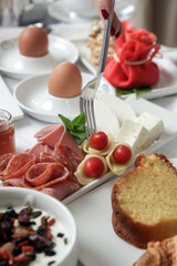 Classic hotel breakfast with various choice of food, eggs, cereals, pastry, jam, cheese and salami	