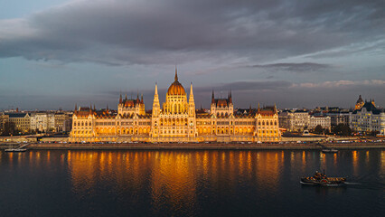 Fototapeta premium Budapest Parliament Building at night with the Danube River reflecting the lights.