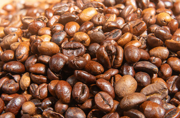 Tightly packed roasted coffee beans fill the frame in a rich brown mosaic. Their shiny surfaces highlight freshness and bold flavor.