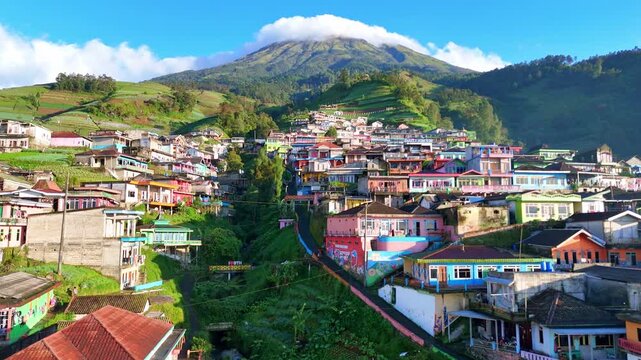 Drone video of a peaceful hillside village nestled among terraced agricultural landscapes in tropical highlands.Nepal Van Java Village, Mount Sumbing, Indonesia.