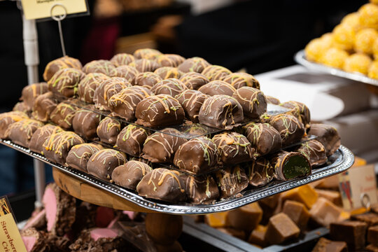 Zurich, Switzerland, November 22 2025. Variety of chocolate truffles and handmade British fudge on display trays at one of the Christmas market shops or stalls