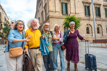 Group of senior friends traveling, walking in city street