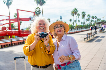 Fototapeta premium Senior couple traveling having fun taking pictures