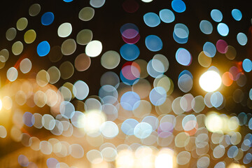 Abstract background of blurry city lights or bokeh lights at night. Blurry Christmas string lights,...