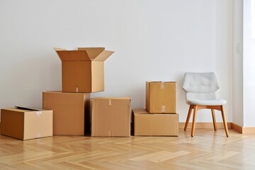 Stacked Cardboard Boxes and Modern Chair in Empty Room – Moving or New Home Concept