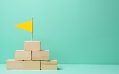 Wooden blocks stairs leading to a yellow flag symbolize success achievement progress and growth on teal background. High quality