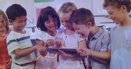 Gathering seven students and teacher pointing and tapping tablet in classroom, showing data overlay