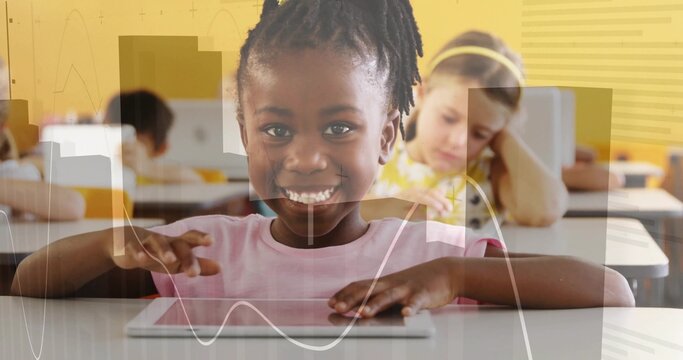 Smiling African American student using tablet at elementary classroom, wearing pink shirt, graphs - Powered by Adobe