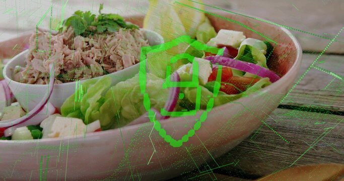 Displaying pastel-pink bowl holding salad on wooden table with white bowl of tuna, green overlay
