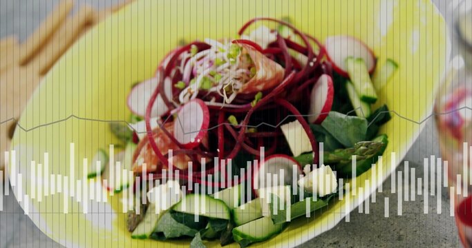 Showing yellow bowl with spiral beet ribbons, smoked salmon, feta on gray table, waveform