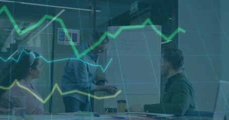 Pointing presenter in light button-up guiding team in small meeting room with flip chart, laptop