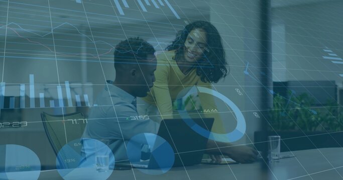 Leaning woman in yellow blouse guiding seated man typing laptop in meeting room, analytics overlays - Powered by Adobe