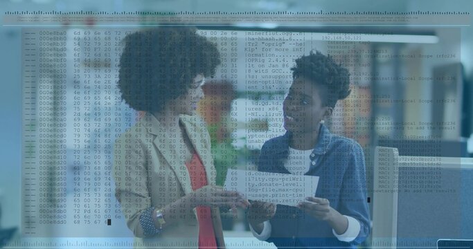 Reviewing two women in beige blazer and denim jacket at office holding documents with code overlay