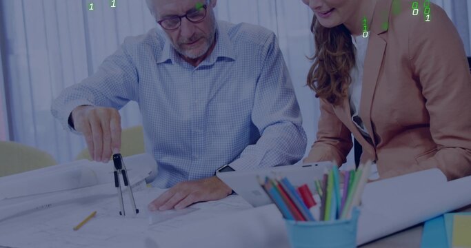 Examining senior man and woman in blazer studying large plans at office, using compass and tablet - Powered by Adobe