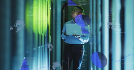 Technician in blue shirt inspecting racks in data center aisle, holding laptop with projected data