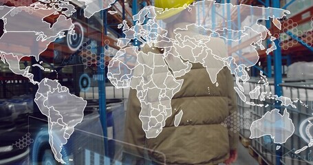 Walking worker in yellow helmet and puffer jacket, storage aisle with blue racks, digital overlay © vectorfusionart