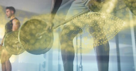 Gripping loaded barbell, lifter in tank top and shorts training at gym with golden bokeh