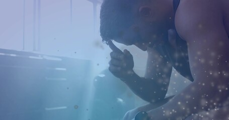 Sitting man holding head on bench beneath high window slats in sleeveless top, blue dust motes