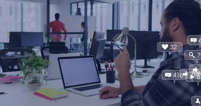 Working bearded man plaid shirt holding phone typing laptop at office with social icons, copy space - Powered by Adobe