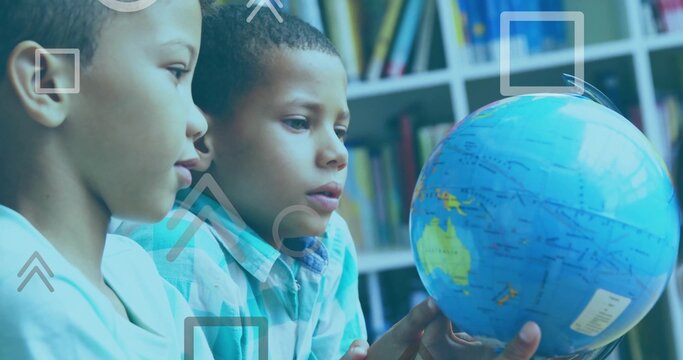 Examining two boys in light and blue plaid shirts, turning globe in classroom with shelf overlays - Powered by Adobe