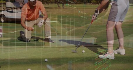 Putting woman in shorts, kneeling partner lining up putt on green with golf balls, market data