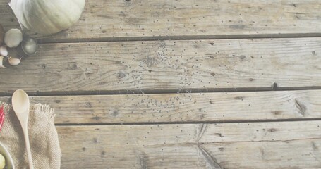 Showing kitchen scene with wooden spoons on burlap, garlic, olives, gourd, pepper, copy space