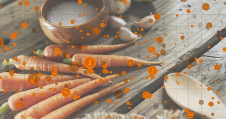 Showing cluster of fresh carrots resting on rustic board at kitchen counter, with dollar icons