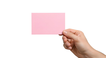 Close-up of a human hand delicately holding a blank, rectangular pink paper card, perfect for customizable messages or branding, isolated on a bright white background