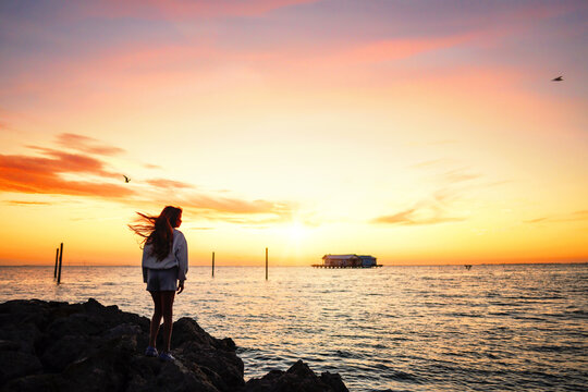 Side view teen girl watching beautiful sunrise Anna Maria City P