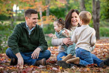 Children goof off as their parents try to wrangle them