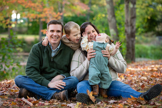 Couple tries to pose with their goofy playful uncooperative youn