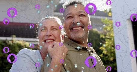 Mature woman wrapping arm around man, causing purple overlay highlighting smart home technology