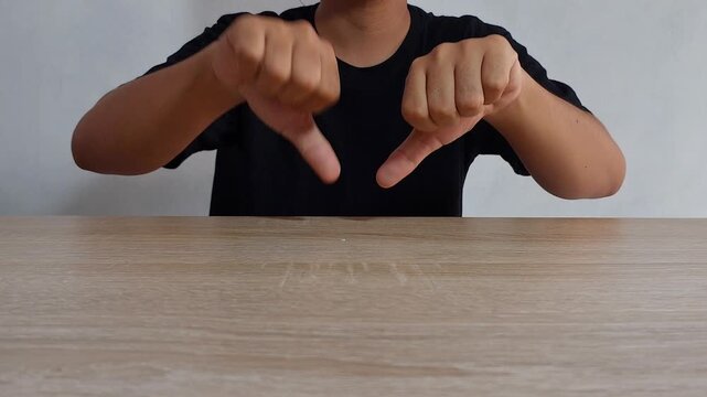 Man Giving Double Thumbs Down Gesture for Absolute Disapproval