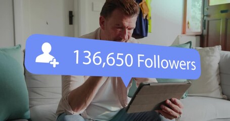 Mature man tapping tablet as blue follower bubble appearing, growing, tracking social media growth