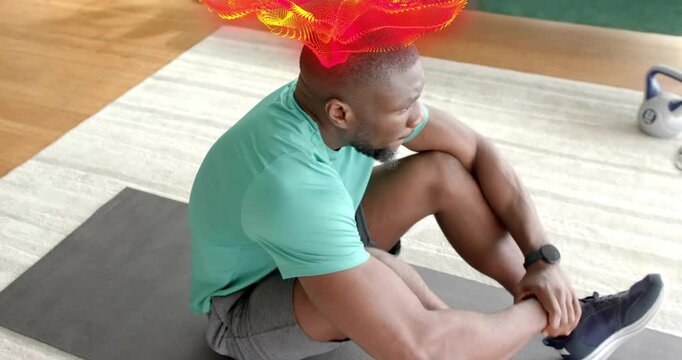 Man pedaling, starting workout, building core, twisting seated rest, particles around torso, phone